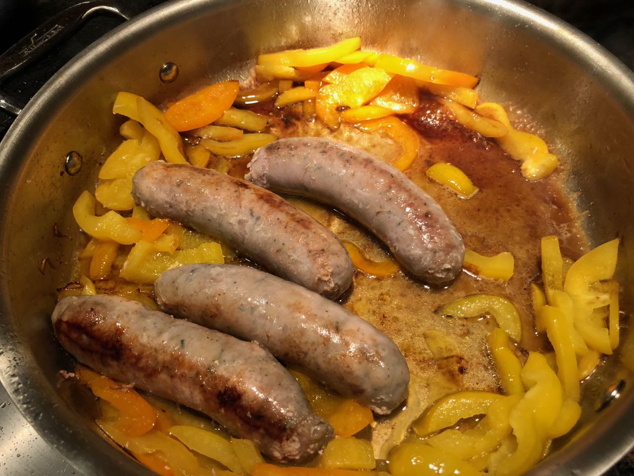 cooking down the sausage and peppers