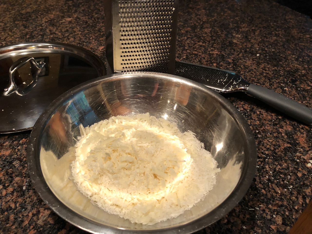 grated romano ready to be added to the pasta