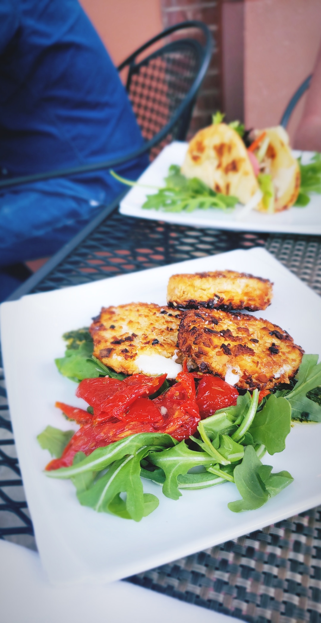 House-made mozzarella is coated with almonds then pan-fried until melty and delicious. Topped with roasted tomato, arugula and basil pesto - Luca's - Keene, NH