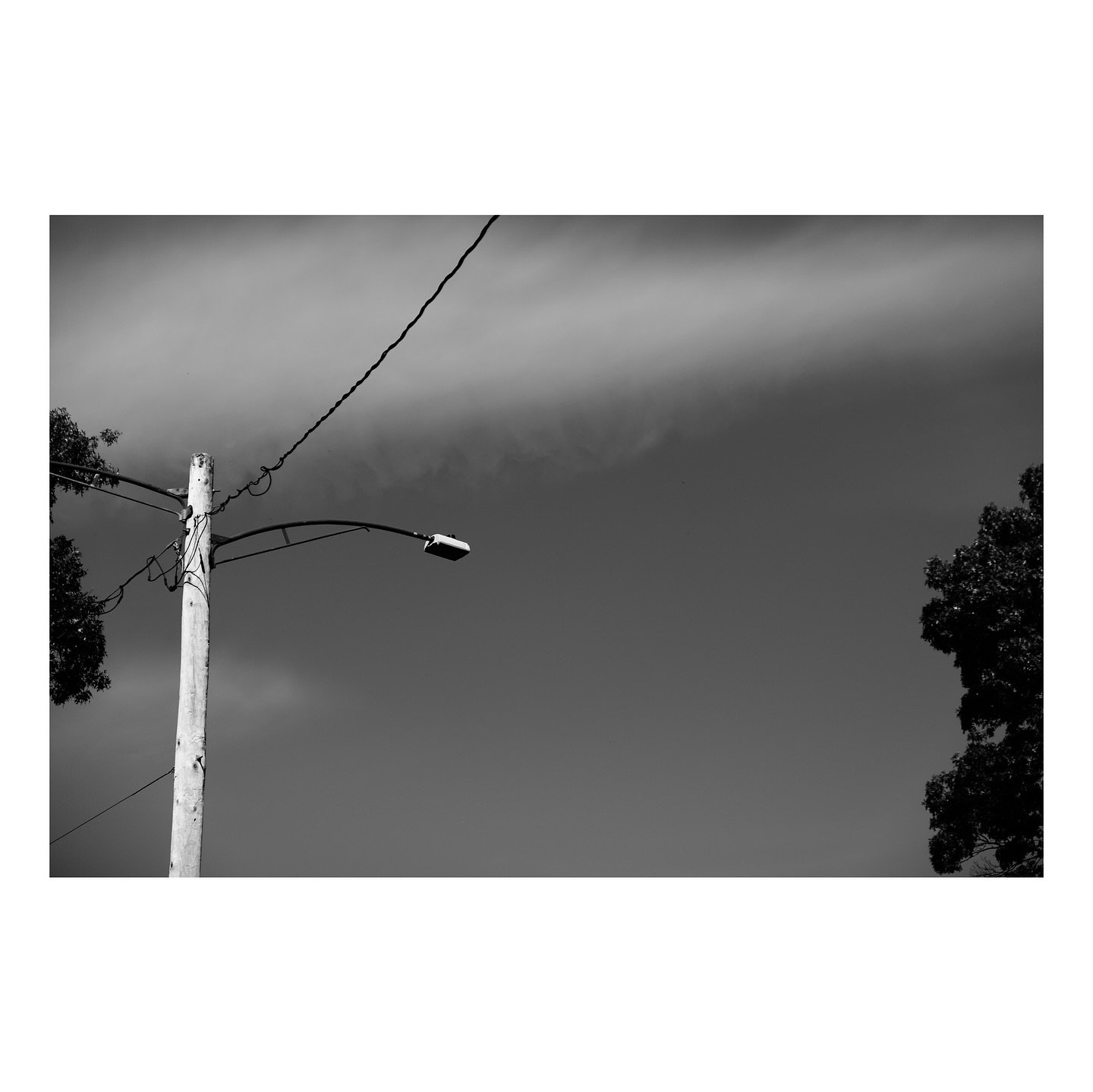 I often find myself drawn to looking up at things like street lamp posts and utility poles of all kinds. I find they make for interesting geometric photographic opportunities. They also provide opportunities for stark contrast with the background sky