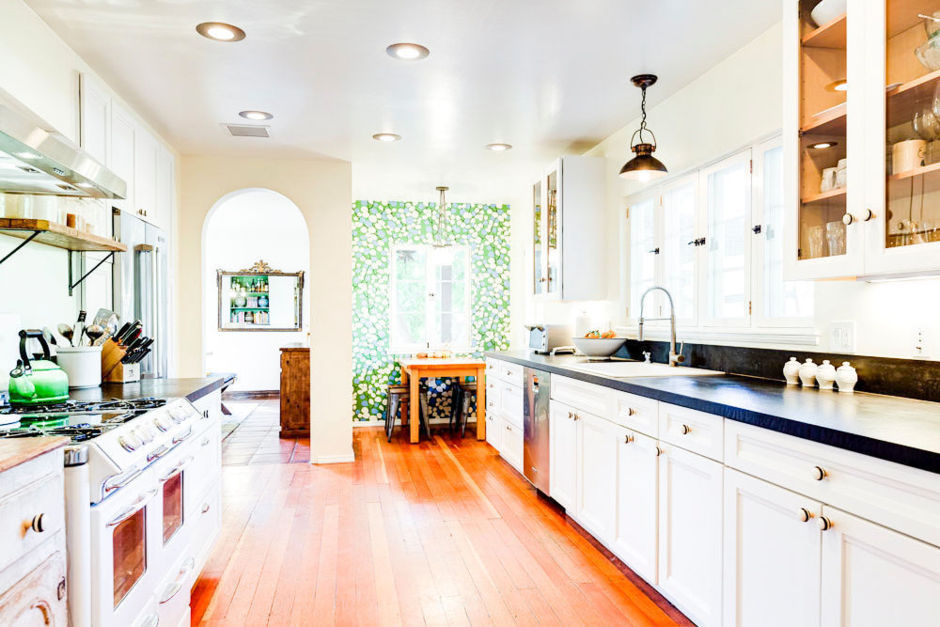 Oh hello cute kitchen with black soapstone counters. The punch of their kelly green wallpaper in the eating nook is to die for. 