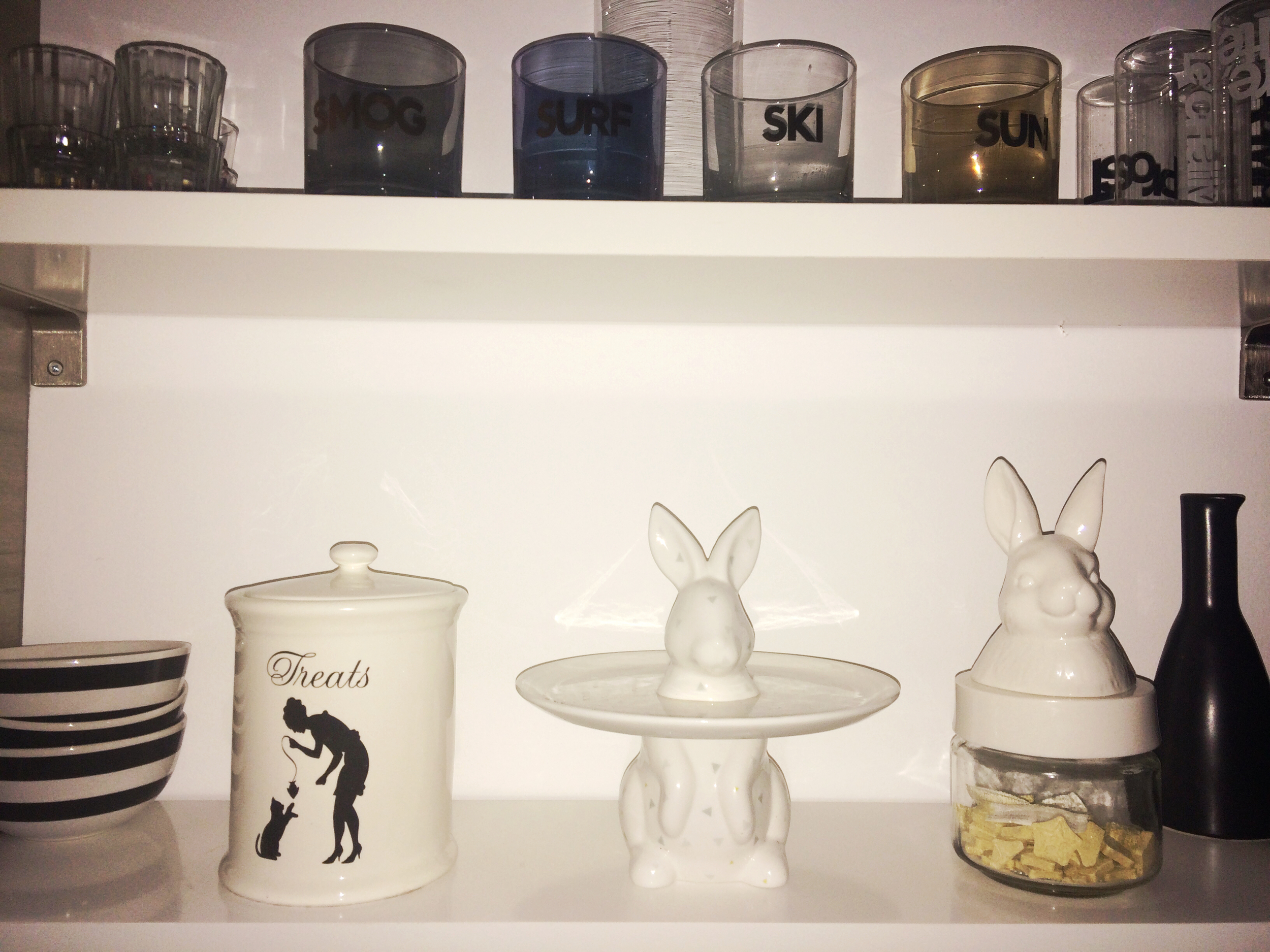 A poor lit shelfie taken at 5am in our rental that showcases our love of all things bunny. Cake stand and jar both from IMM living.