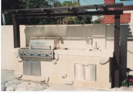 Outdoor kitchen area, stucco with granite stone accents and wood arbor. Gilbert Residence (KRM Garden Design/Build)