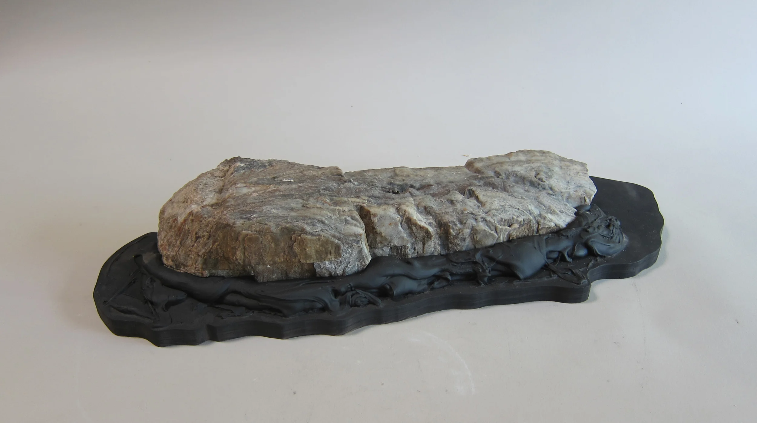   Northern California stone, Bondo, enamel paint, plywood.&nbsp;  