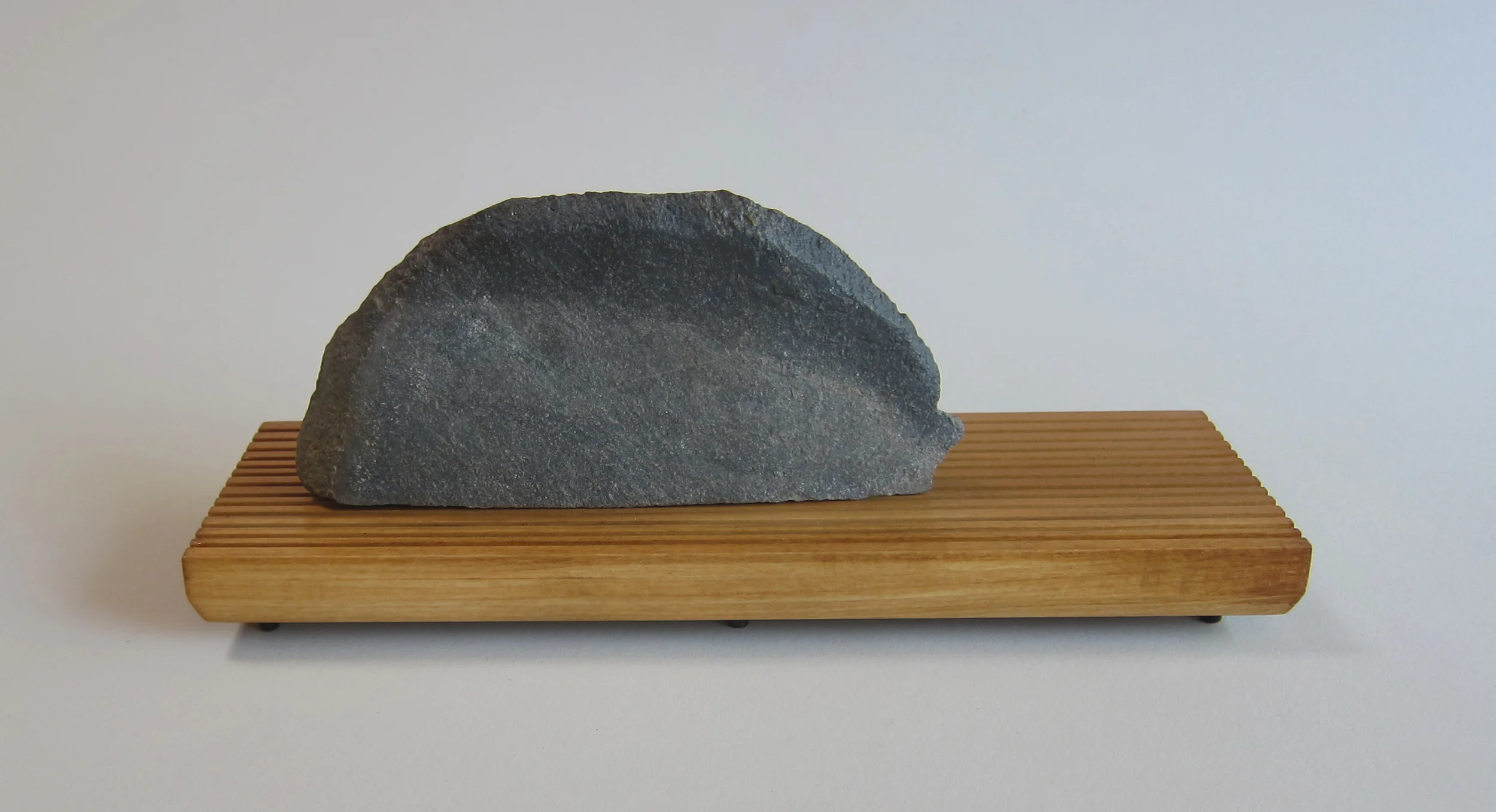   Basalt, wood, painted aluminum.  