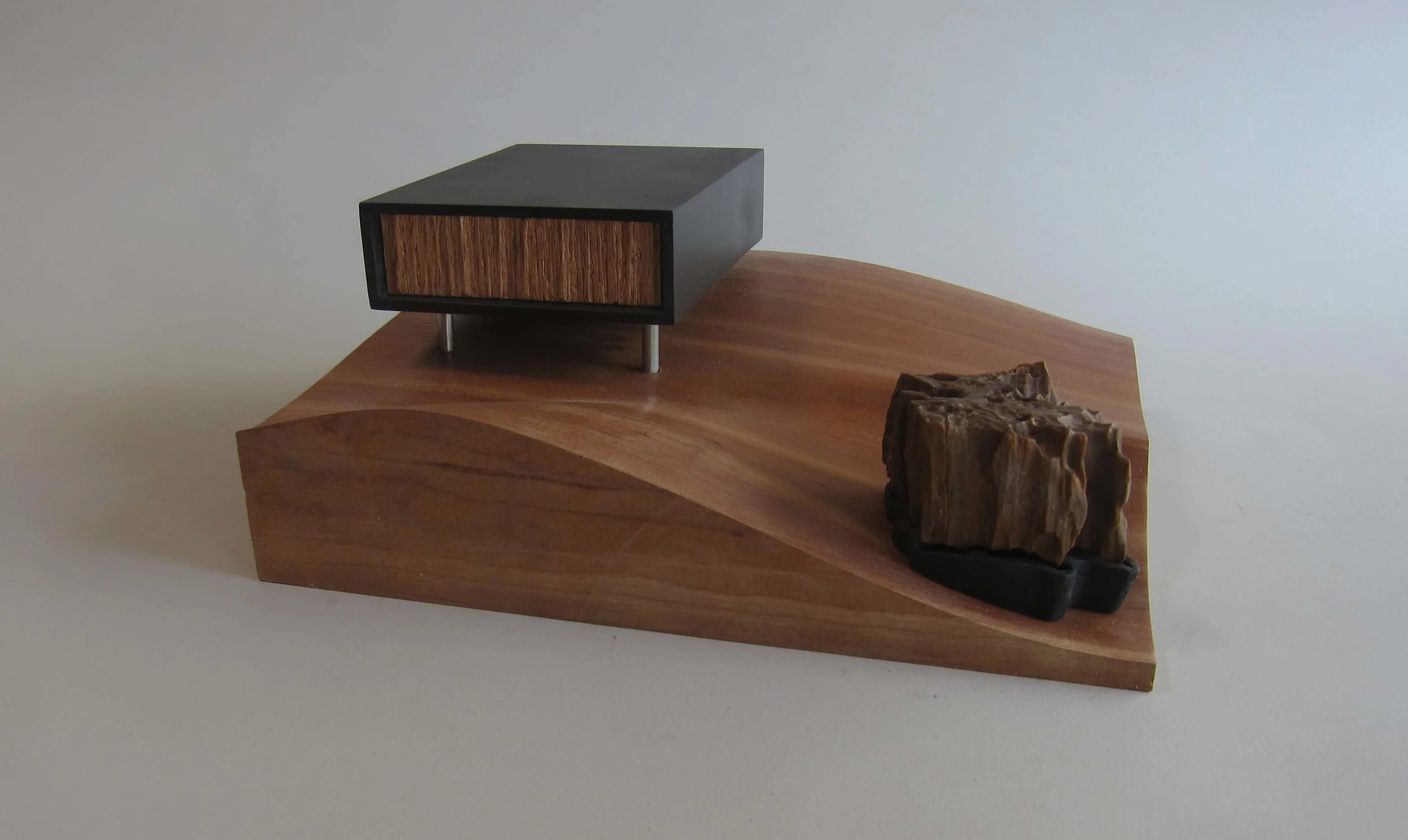   Fossilized wood, enamel paint, wood, aluminum.&nbsp;  