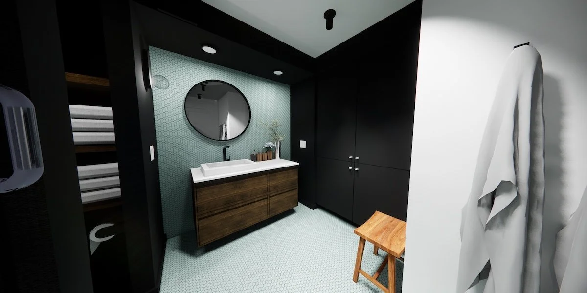 Cool mosaic tiles transition from the floor to the wall adding a pop of colour in the space while framing the soft round mirror and warm walnut vanity.