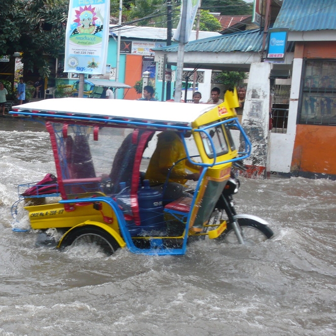 hurricane in the philippines flooding scooter road