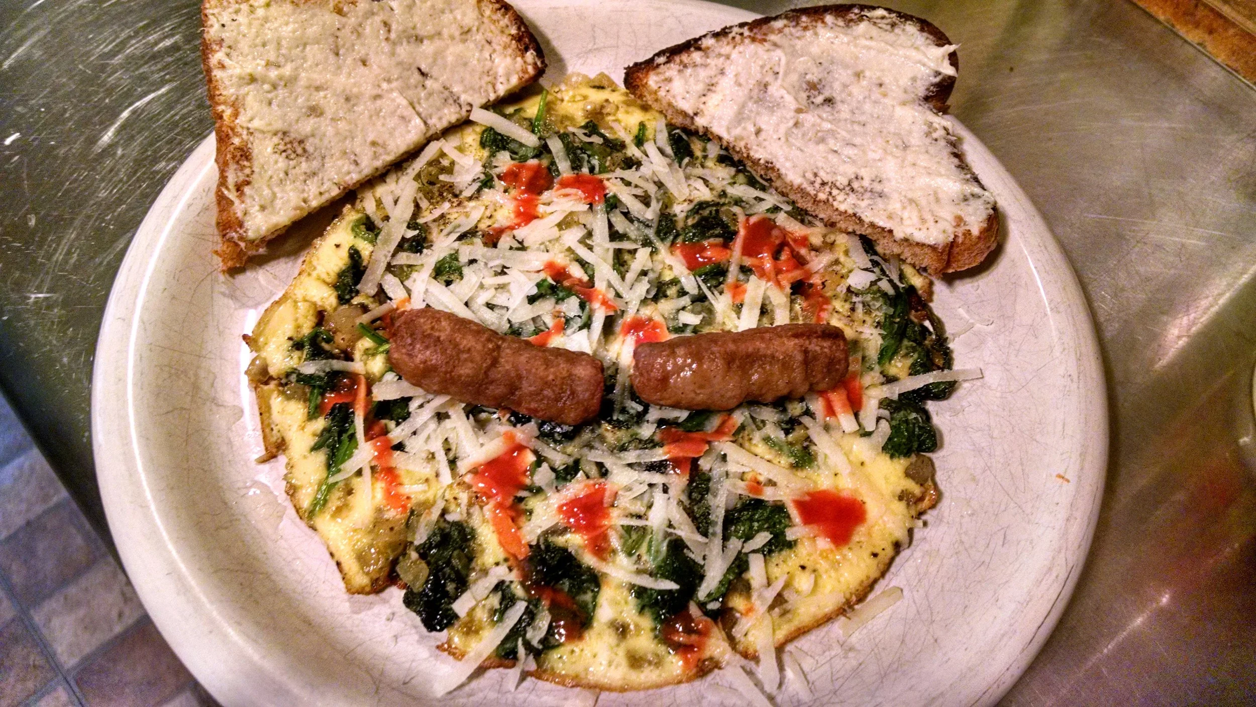 A Hello Kitty Fritatta made with baby spinach, onions, garlic and shredded parmesan cheese. The whiskers are brown and serve sausages, I would have added more for HK authenticity but I'm regulating my calorie intake these days. Also, homemade toast with a schmear of white fish.