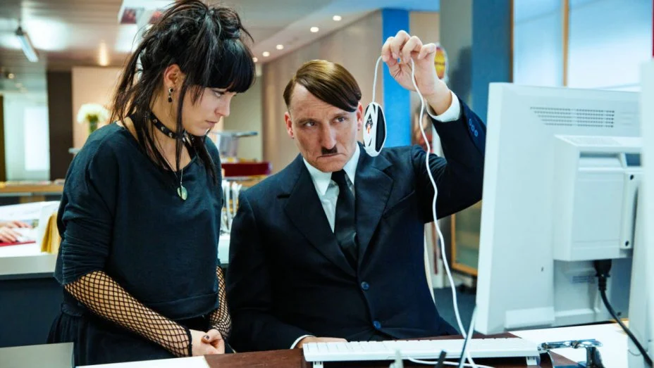 Franziska Wulf as Fraulein Kromeier and Masucci as Hitler