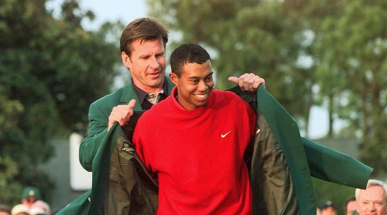 Tiger receiving his Green Jacket from 1996 champion Nick Faldo