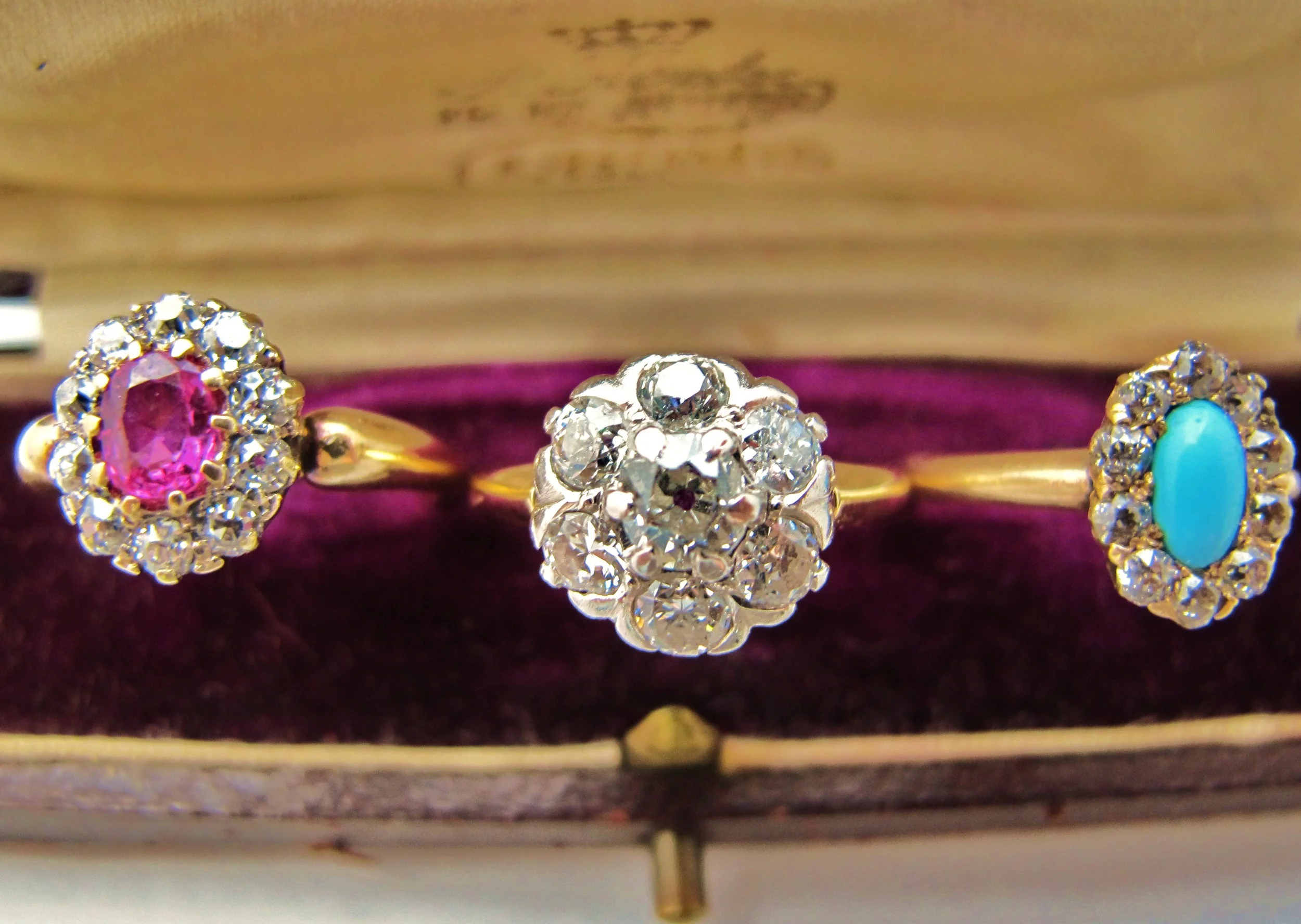 From Right to Left: 18k yellow gold with .56ct ruby and old European diamond surround, 14k yellow gold/platinum with 1.4cts of old European cut diamonds, 14k yellow gold with Persian turquoise cabochon and old European cut diamond surround.
