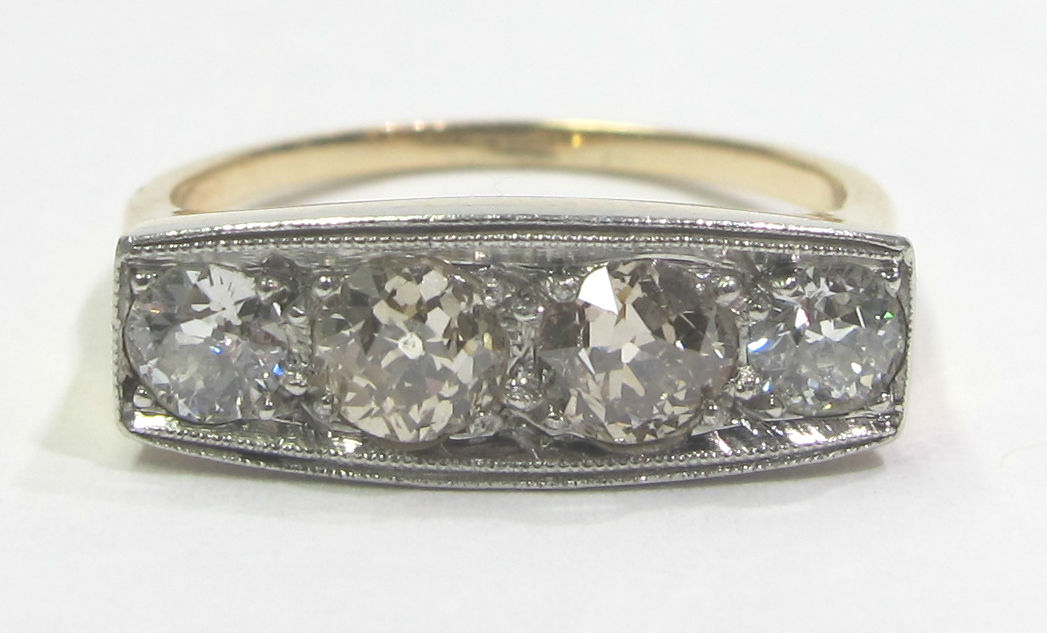 Late Victorian 14k gold and platinum ring with four diamonds totaling 1.80cts of diamonds, at Gray & Davis. Color ranges K-P, and contributes to the overall design of the ring.