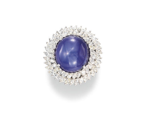 From Christie's: Set with a cabochon star sapphire within a two-tiered marquise-cut diamond surround, mounted in platinum,