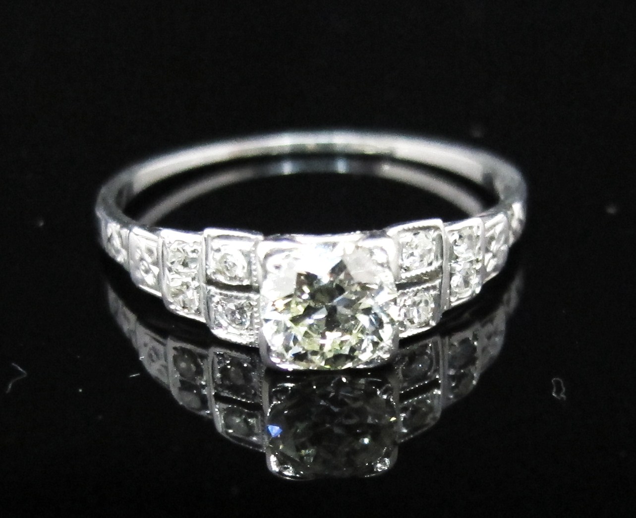 18k white gold with .53ct L color, VS2 clarity old European cut center diamond and eight single-cut accent diamonds. Art Deco, c.1925.
