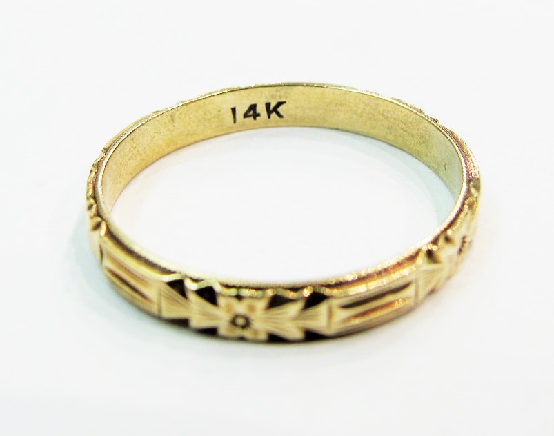 Vintage yellow gold wedding band with a typical "14k" stamp to indicate its gold content. 