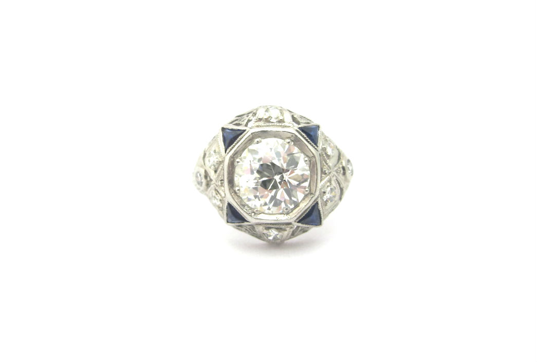 Art Deco diamond ring with 1.54 carat old European cut center and sapphire accents. Currently available in our online shop!