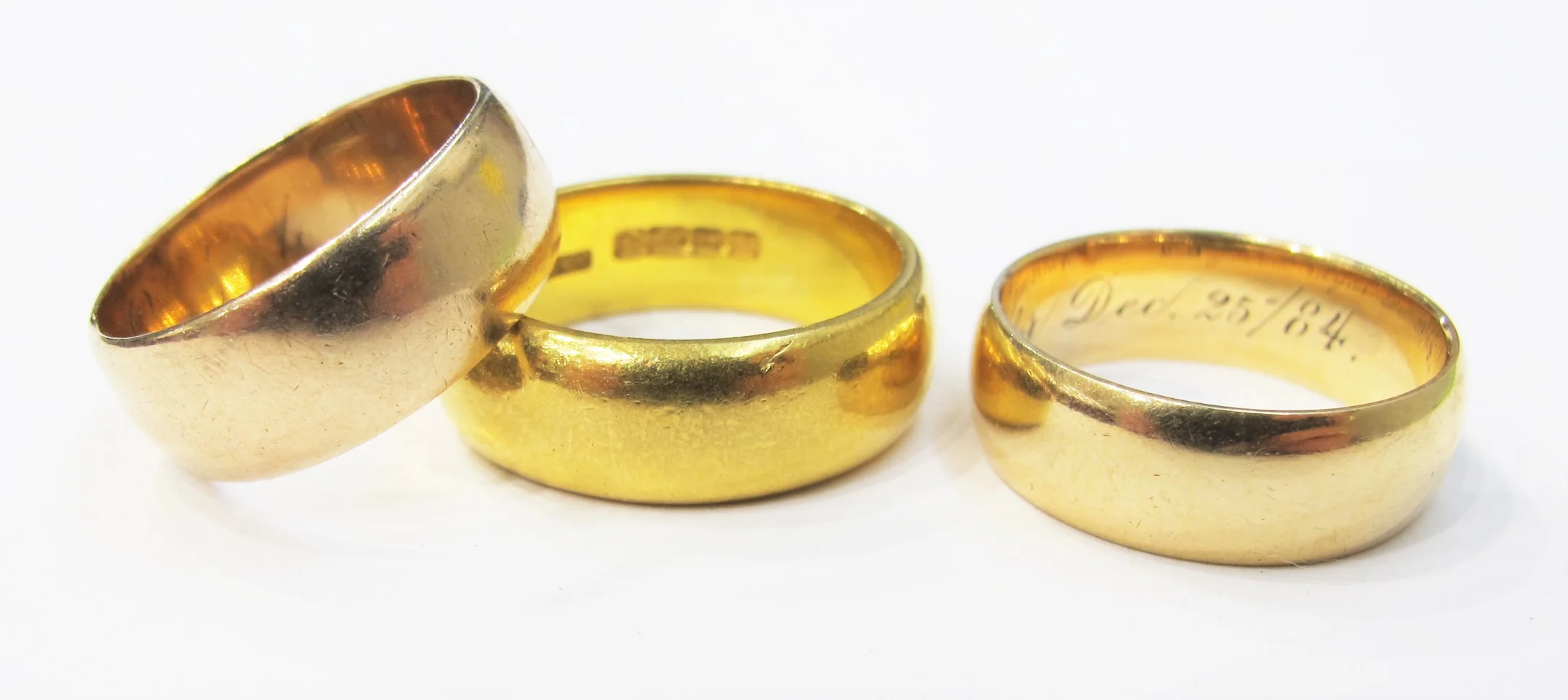 Three gold wedding rings dating c. 1890, 1870 and 1884 respectively. 