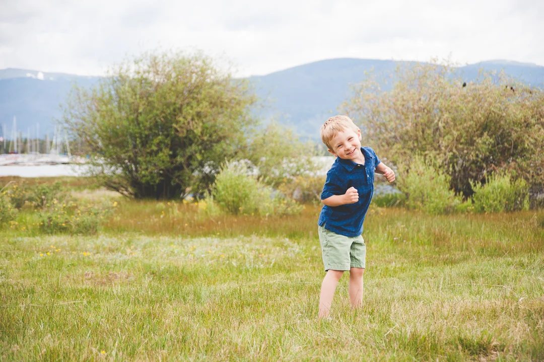 A young boy goofs around and acts silly in between other family shots at their Lake Dillon, Colorado family photo shoot.