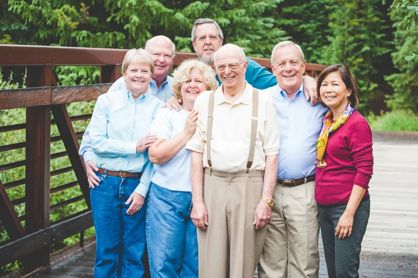 Dad and his children and their spouses gather close for a sweet family photo during vacation at Copper Mountain Resort.