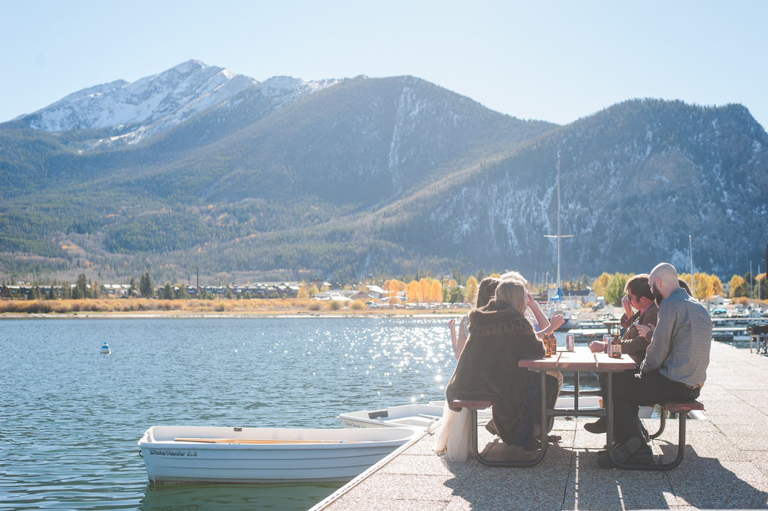 A snowy-topped Peak One stands tall over Lake Dillon, as the intimate party moved to the docks a the Frisco Marina. Champagne, laughter and a cool autumn breeze filled the afternoon. | Keeping Composure Photography