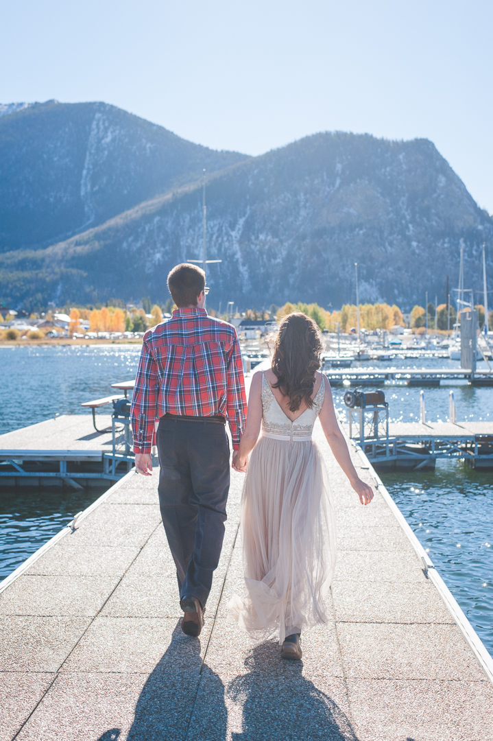 Late afternoon "magic hour" light floods the docks of at the Frisco Marina as this newly-wed Bride and Groom head off to their next great adventure together! | Keeping Composure Photography