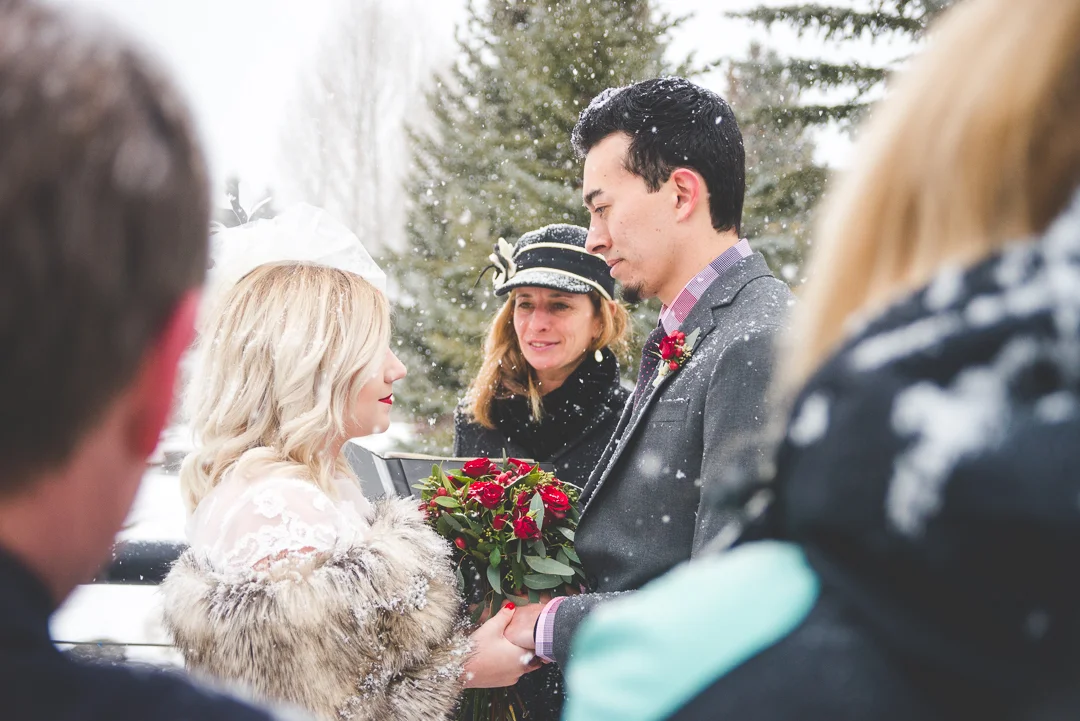 A snowy mountain elopement in the middle of winter, in the heart of Breckenridge, Colorado | Red wedding accents that pop in the white snow | Keeping Composure Photography