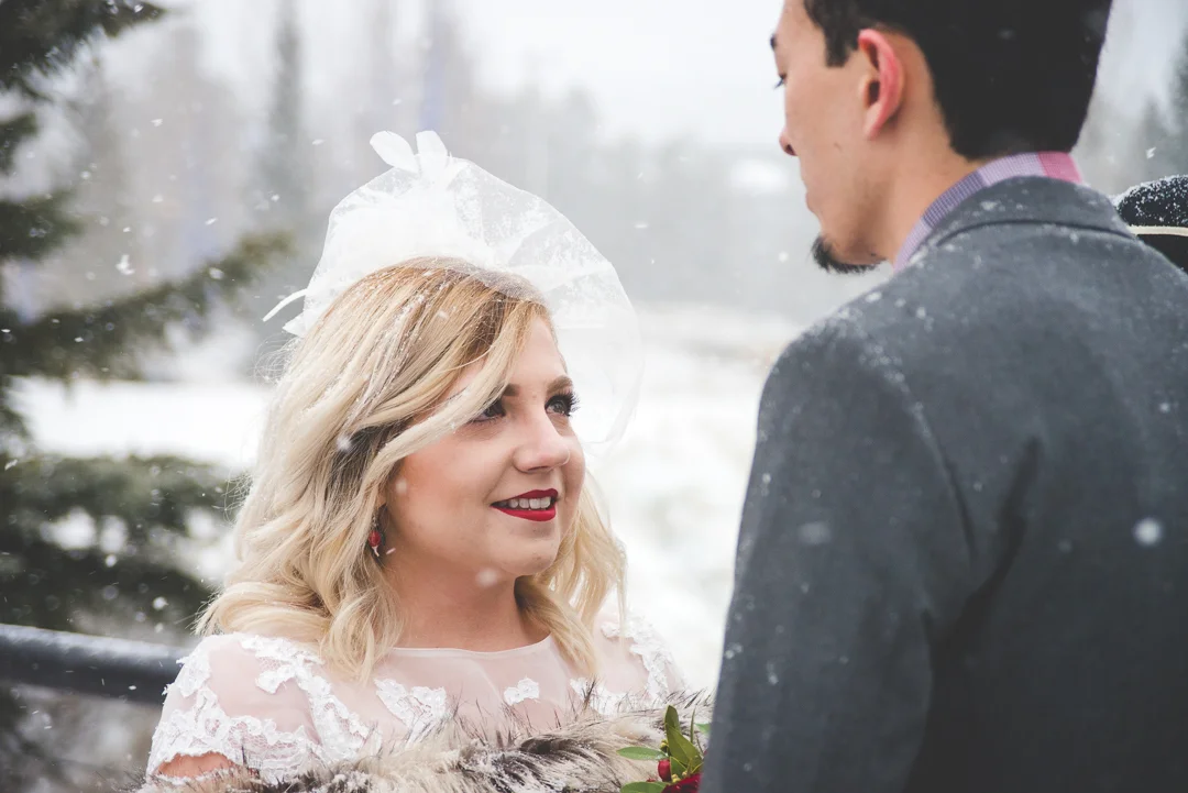 A snowy mountain elopement in the middle of winter, in the heart of Breckenridge, Colorado | Red wedding accents that pop in the white snow | Keeping Composure Photography
