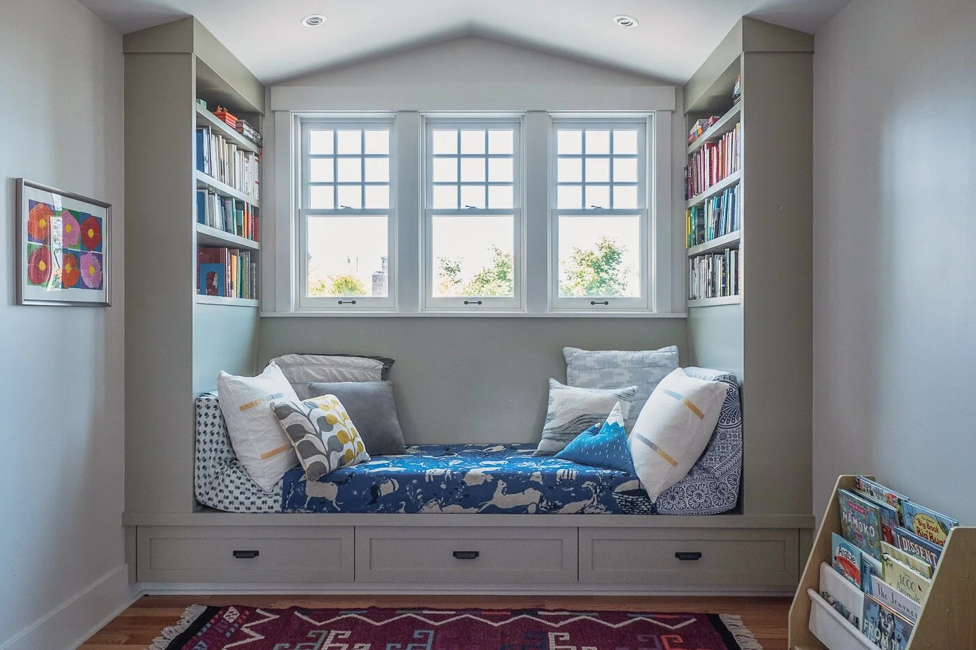 Piano Nobile residential interior with built-in window seat, bookshelves, and custom storage.