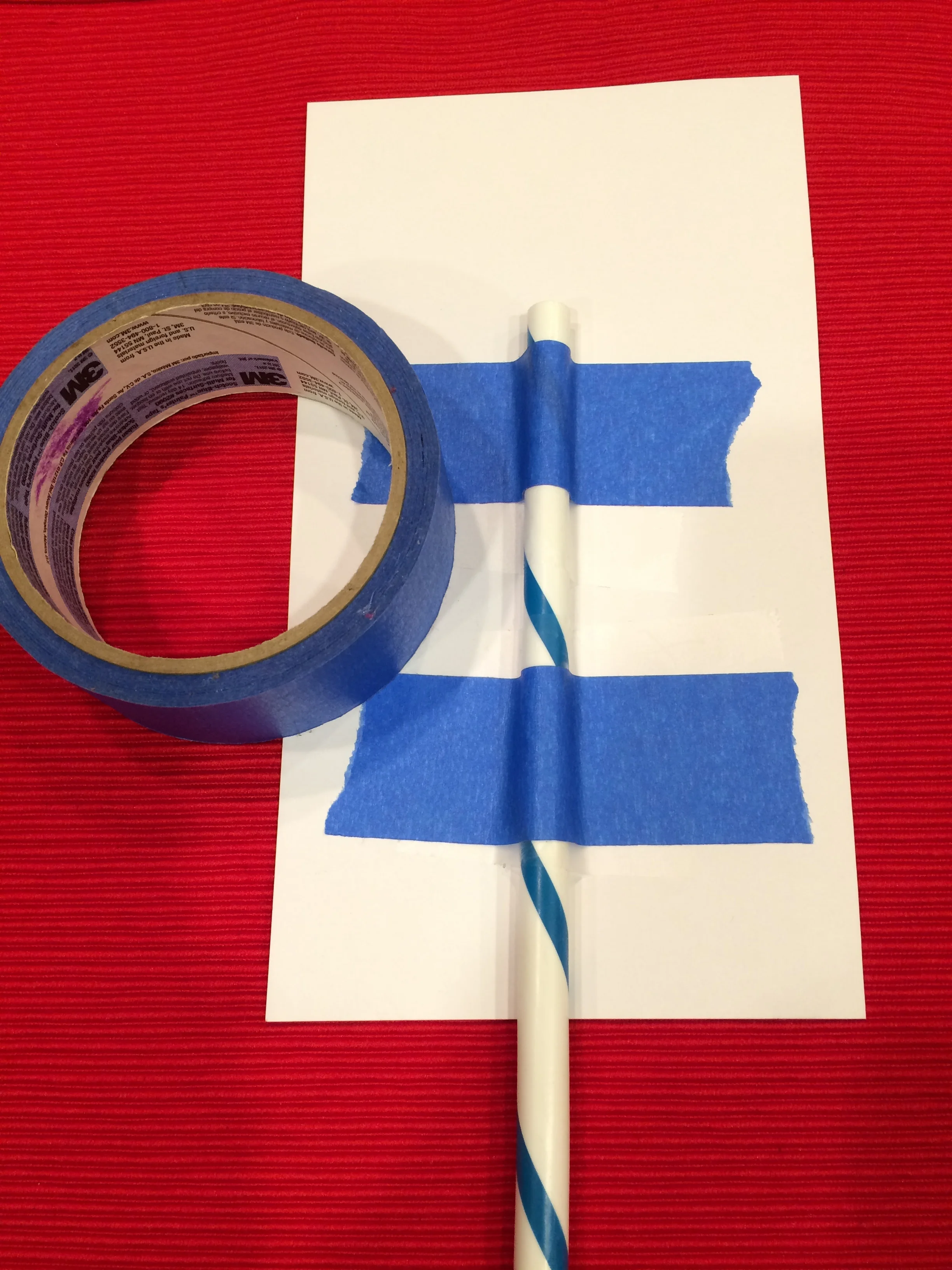 Tape a heavy duty straw or decorated dowel to the back of your card stock.