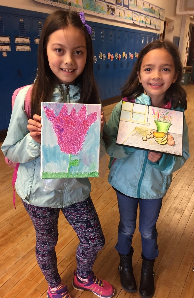 Fellow second graders, Maya Veitengruber and Madeline Alviar, at McGilvra Elementary School show off their completed artwork.