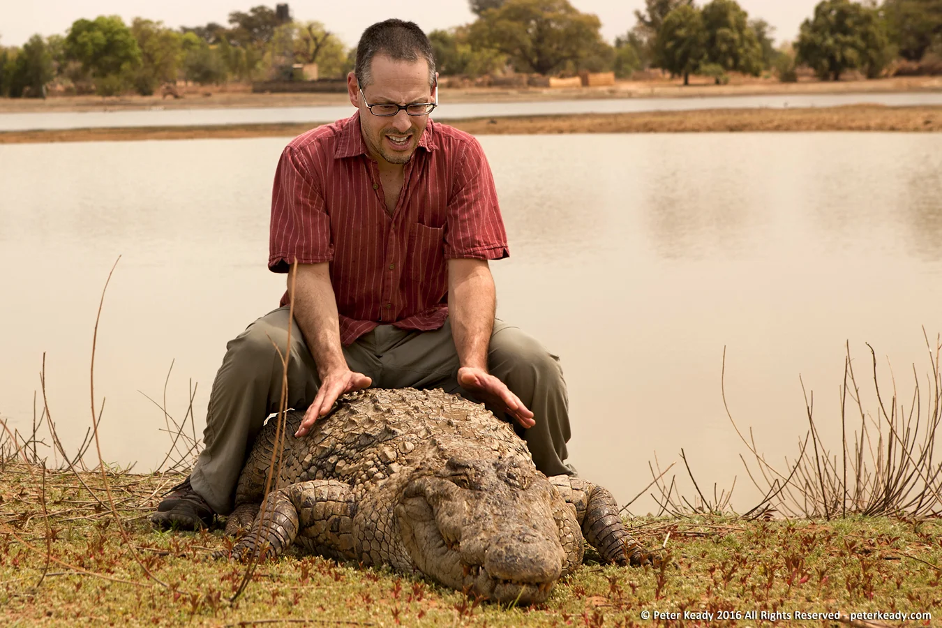 I'm far more nervous than I appear in this photo. Some of the group refused to touch the crocodile. What you don't see, just out of frame, is the man with the stick. He was my hero!
