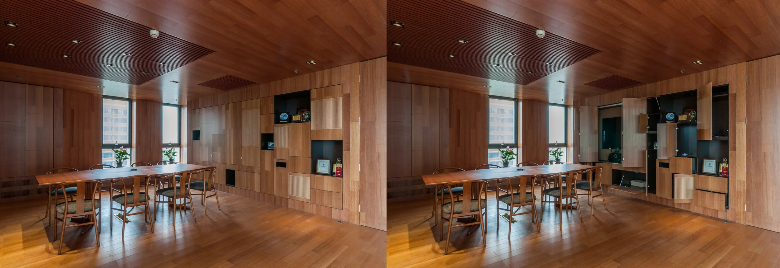 The wall opens up to reveal an integrated video conference system and storage features.