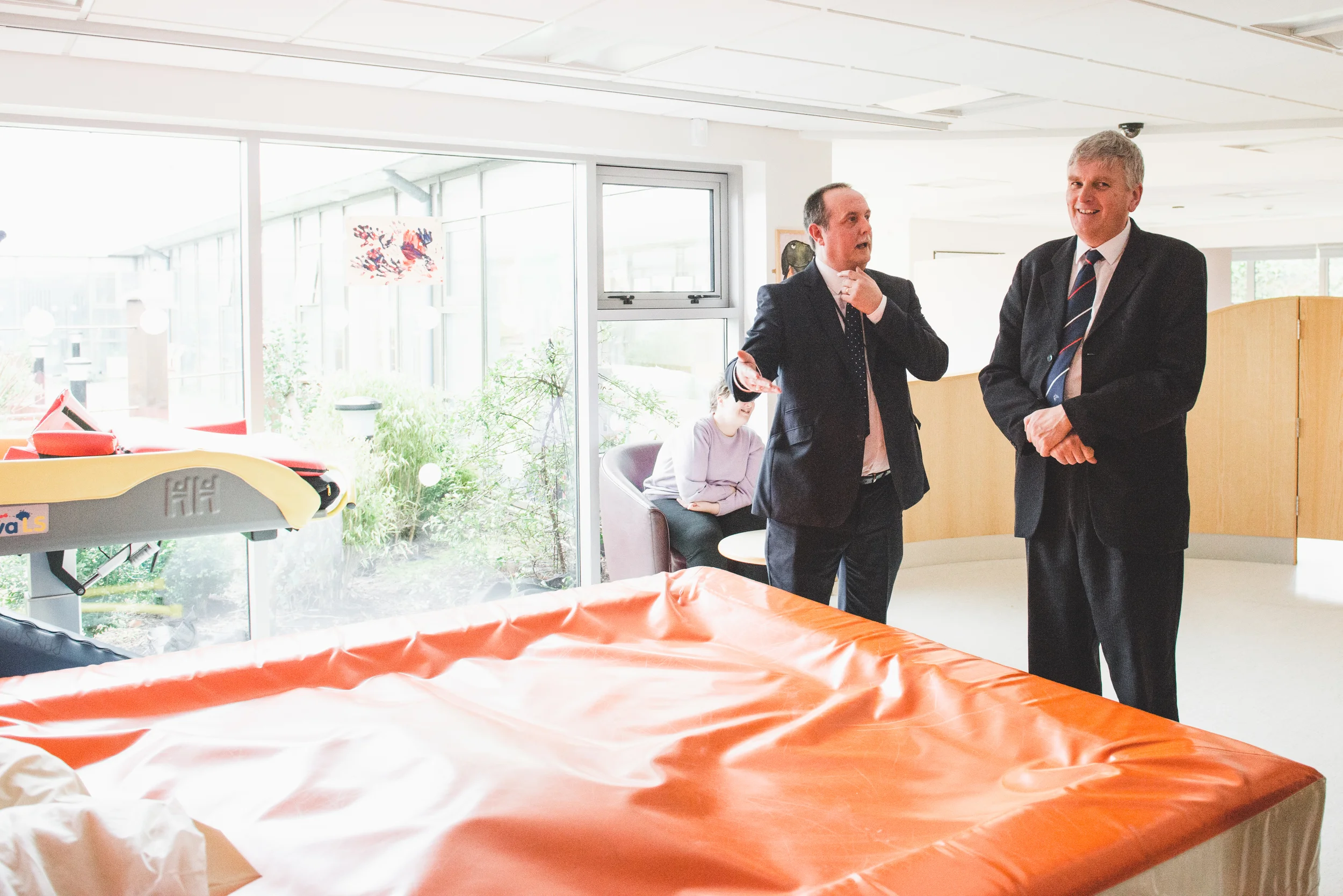 Raphael Kearns of the Lisburn Assessment & Resource Centre shows Health Minister Jim Wells the Centre ' s facilities