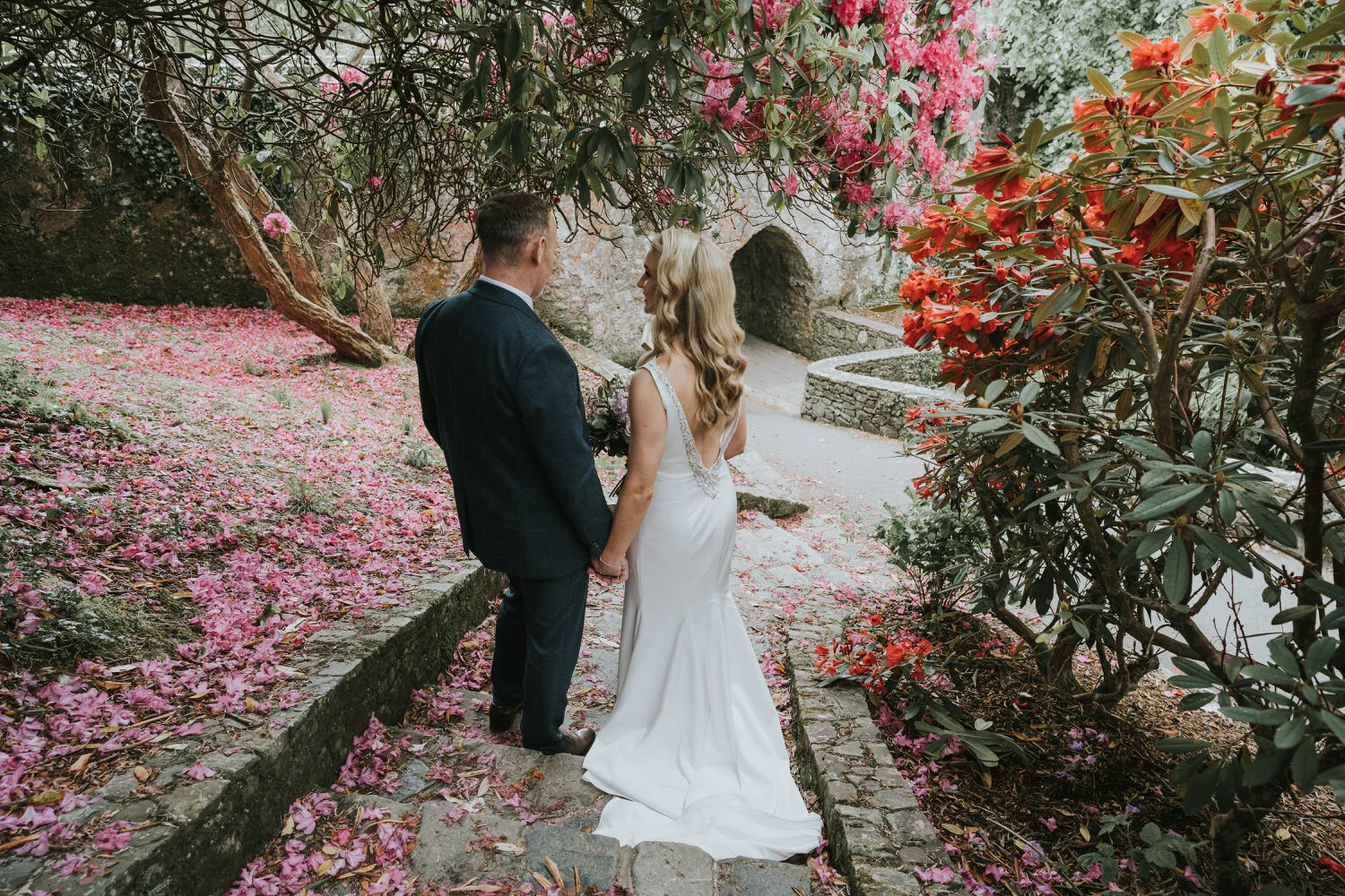 Couple portrait on steps among flowers from a Slieve Donard wedding