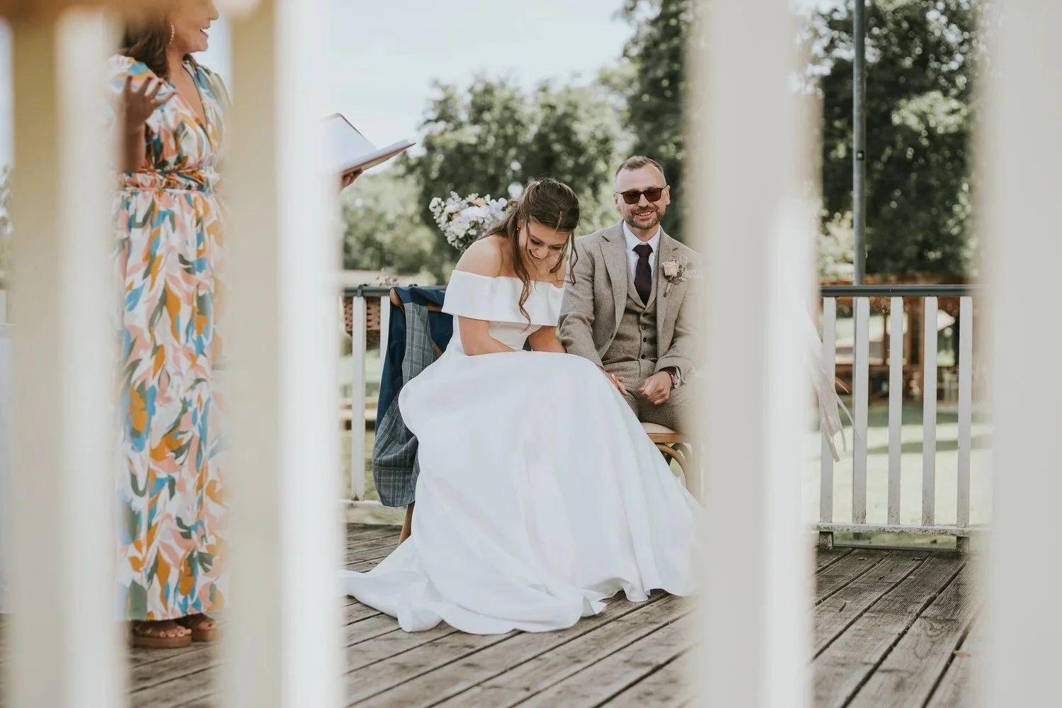 Bride and groom sharing a genuine, joyful moment together on their wedding day, laughing candidly outdoors