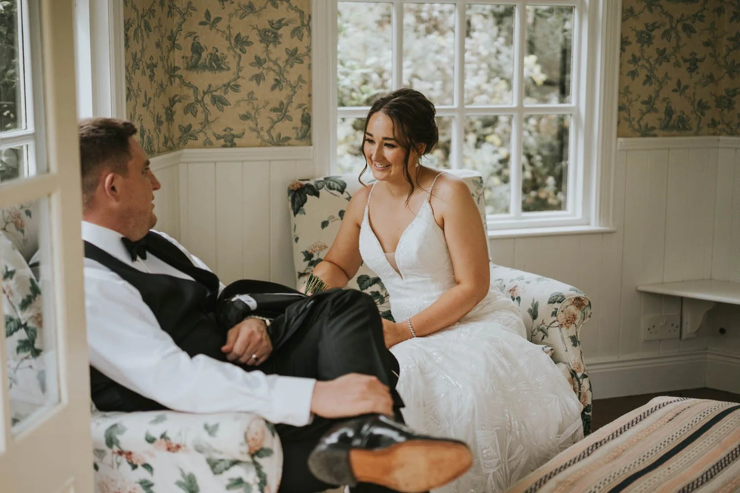 Bride and groom relaxing in a bright sitting room at Tullyveery House
