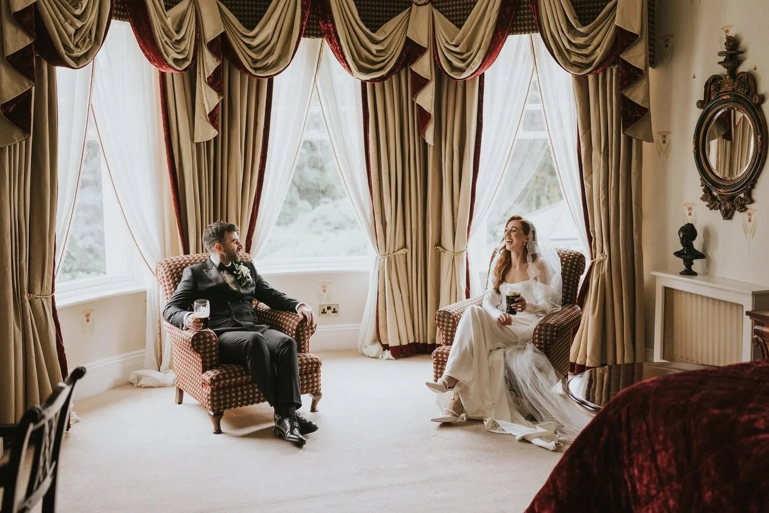 Bride and groom sharing an intimate, joyful moment alone together in an elegant room, laughing and looking at each other