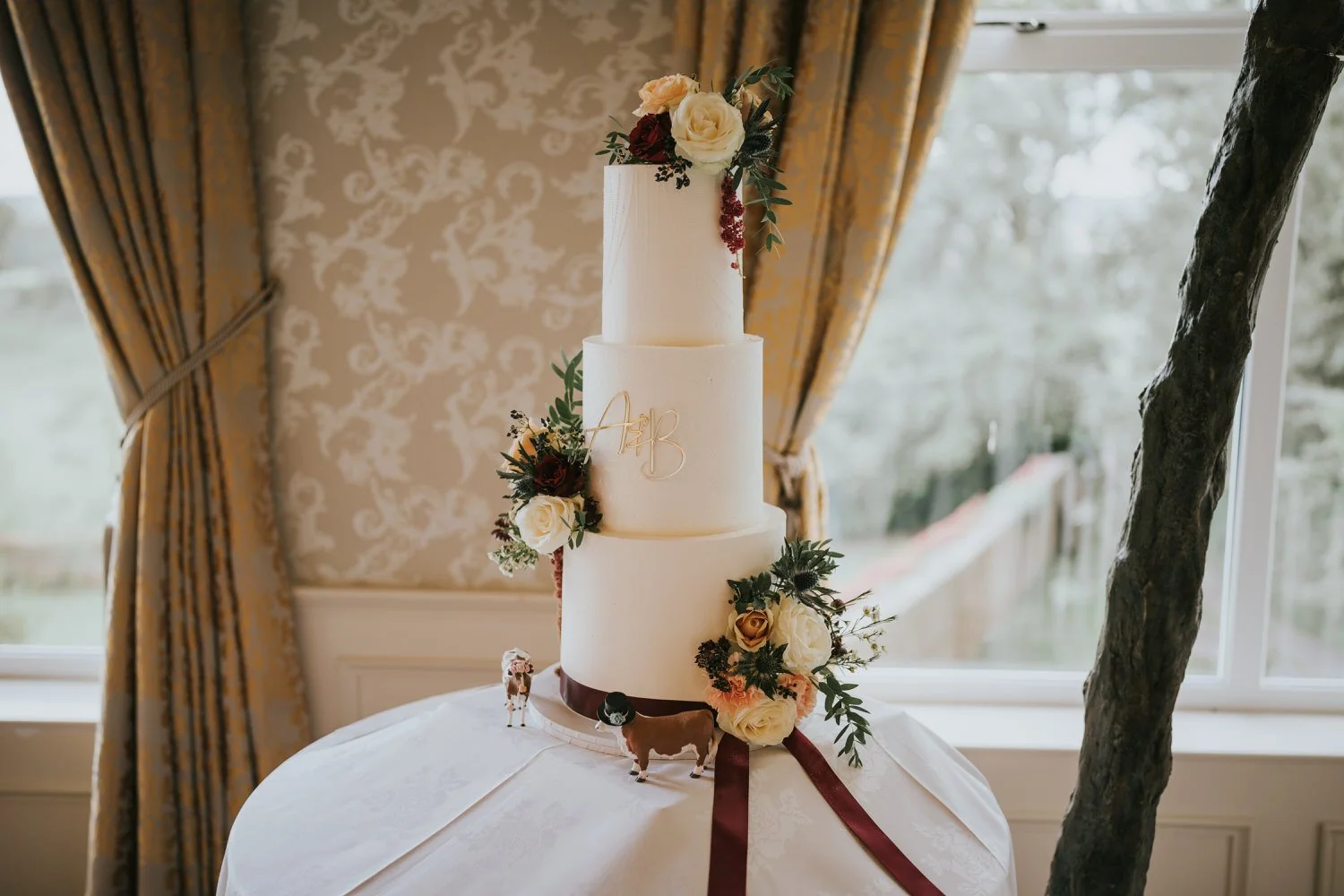 Wedding cake on a table in the dining room at Corick House Hotel and Spa