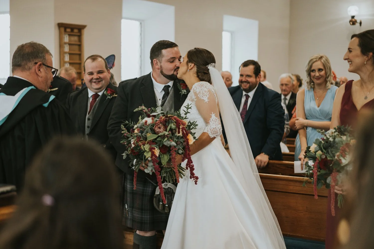 Bride and groom walking up the aisle after their church ceremony