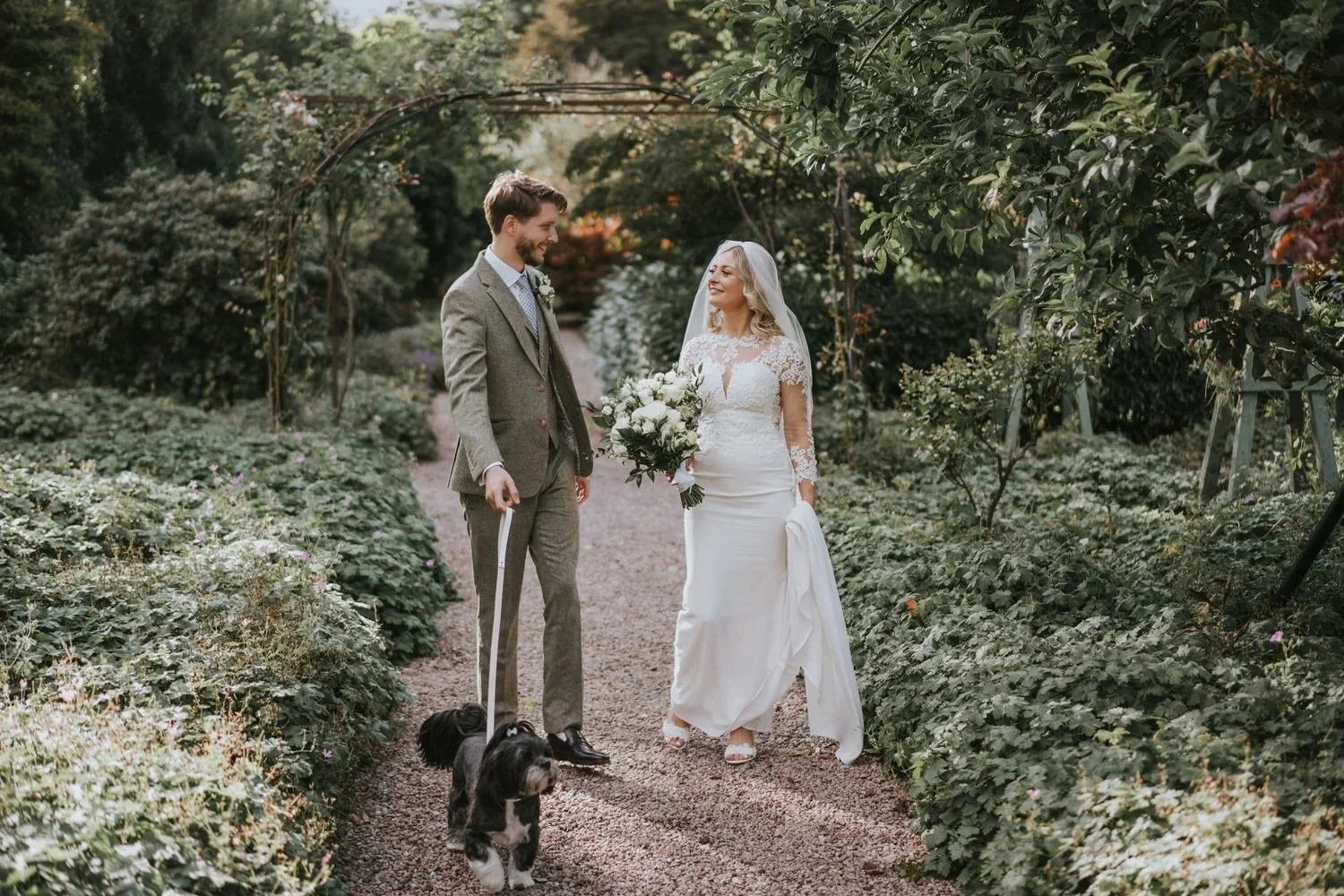 Debi and Darren walking through the walled garden at Larchfield Estate