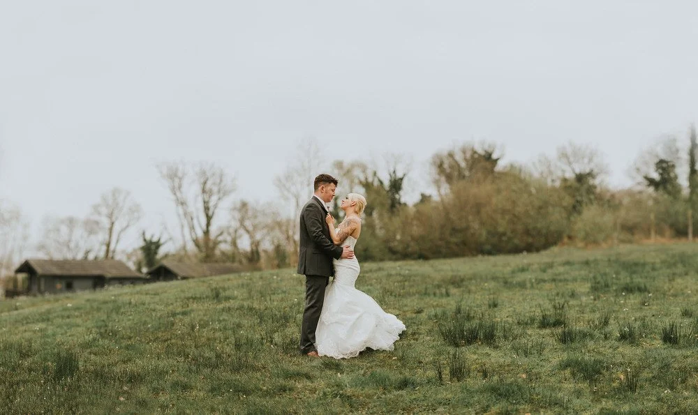 Bride and groom dancing together in a grassy field on Lusty Beg Island