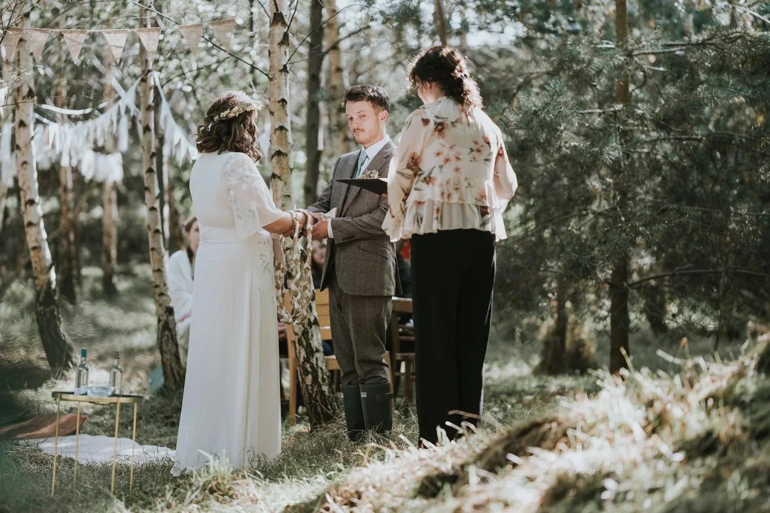 Couple exchanging vows during an intimate outdoor micro wedding ceremony in a woodland setting in Northern Ireland, photographed by Pure Photo NI