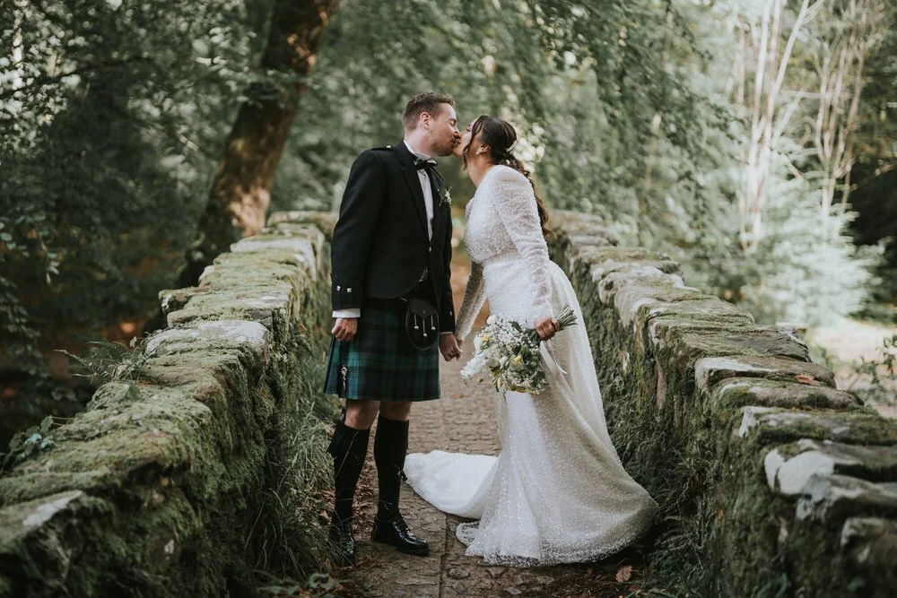 Bride and groom on a stone bridge at Tollymore Forest Park near Newcastle