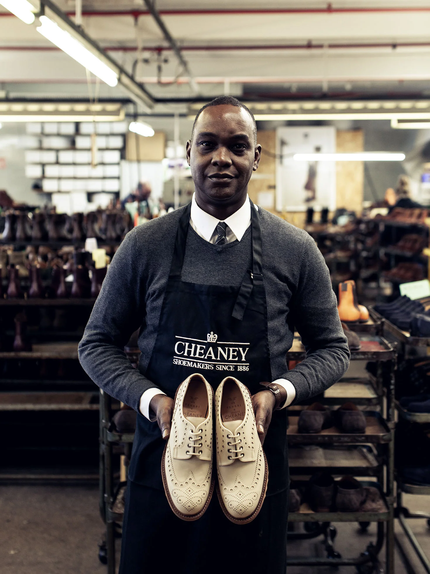 Shoemaker holding a pair of Apex Brogue shoes