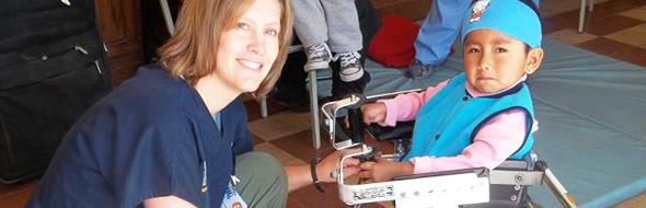 Jodee Fortner, PT in Peru with a young patient
