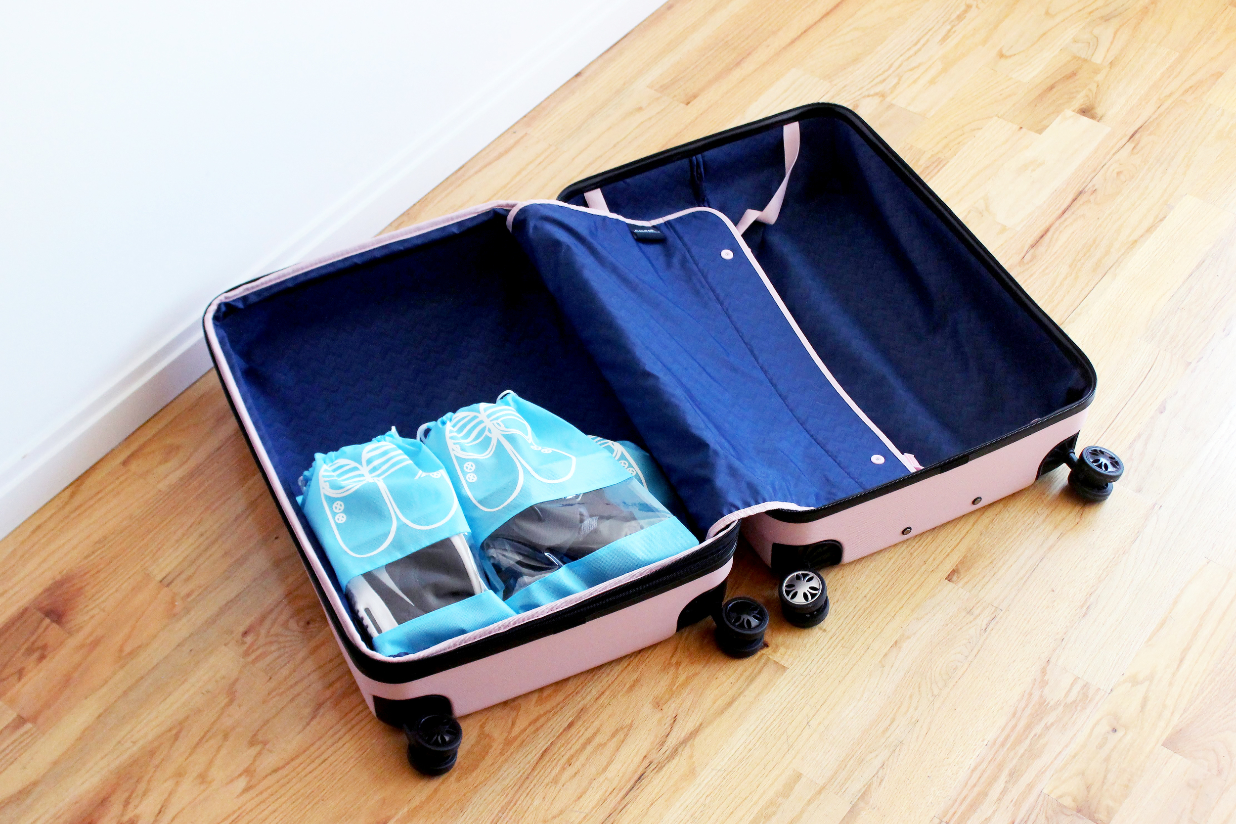 Shoes packed on the bottom of the CalPak Davis suitcase