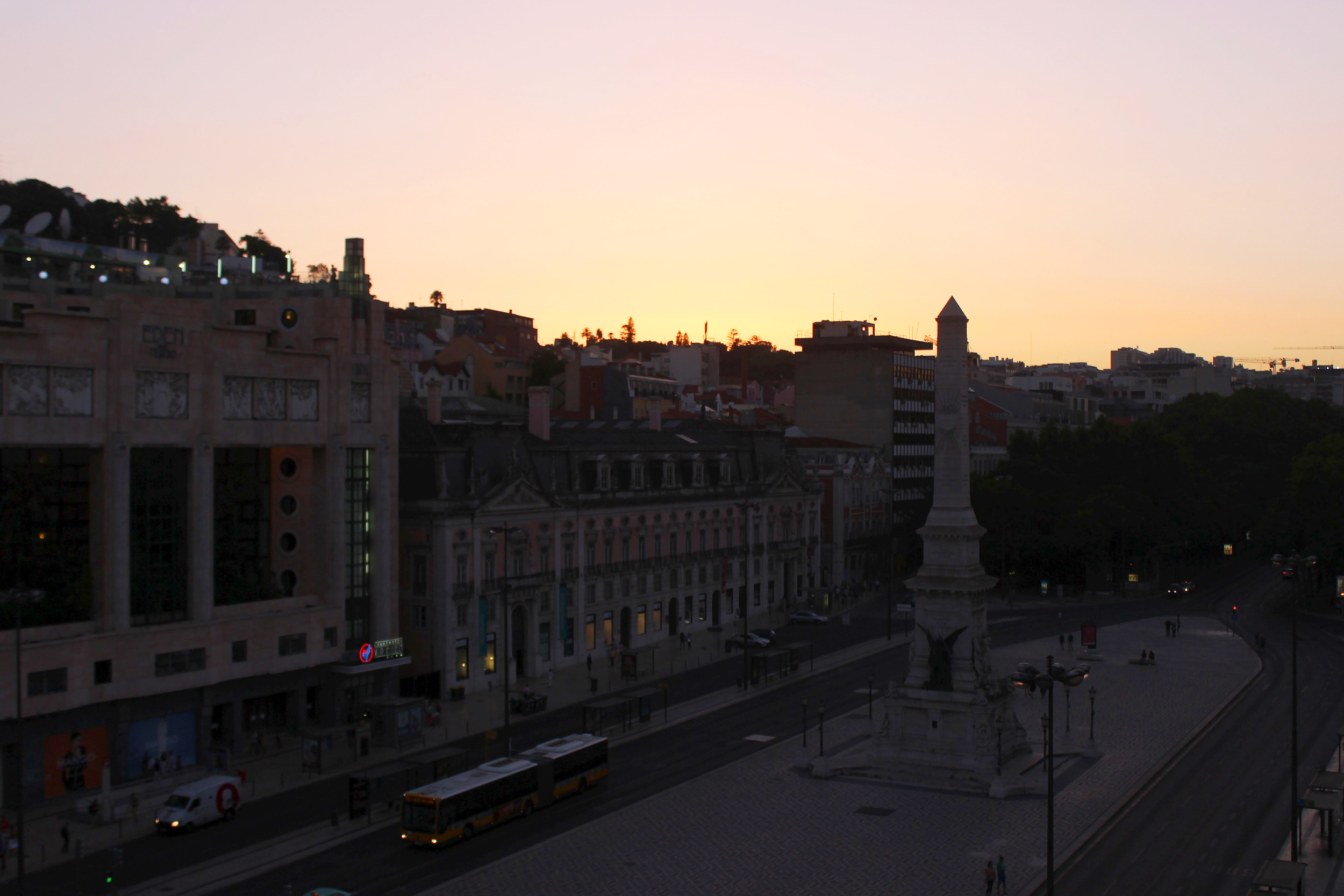 Watching the sunset from our balcony that overlooks the Praça dos Restauradores (Resauradores Square)