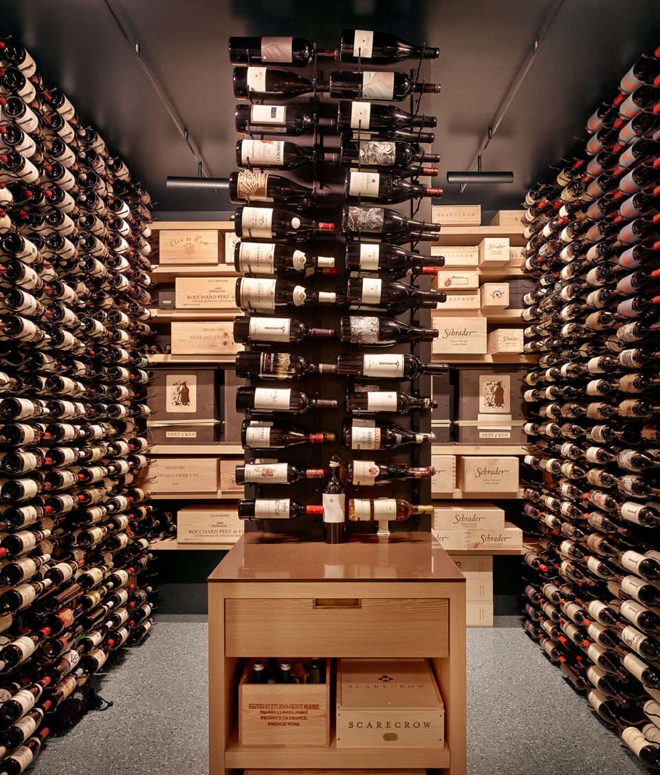 3000 bottle capacity wine room using triple-deep Vintage View label view racking with storage drawer, LED lighting, open + adjustable sinker cypress shelving for case display. Concealed mini-split cooling unit on backup generator.