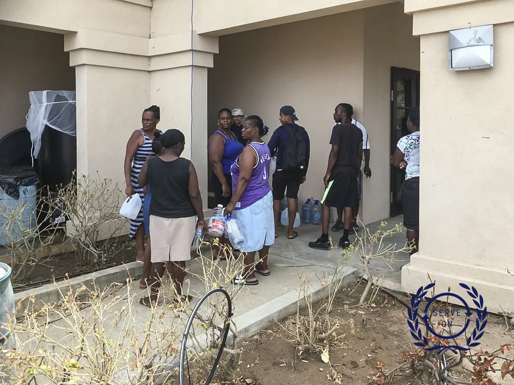 Serve Ons Andy Harris dispensing 2000 litres of water to a queue of locals